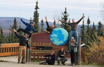 NSE students posing with Arctic Circle sign