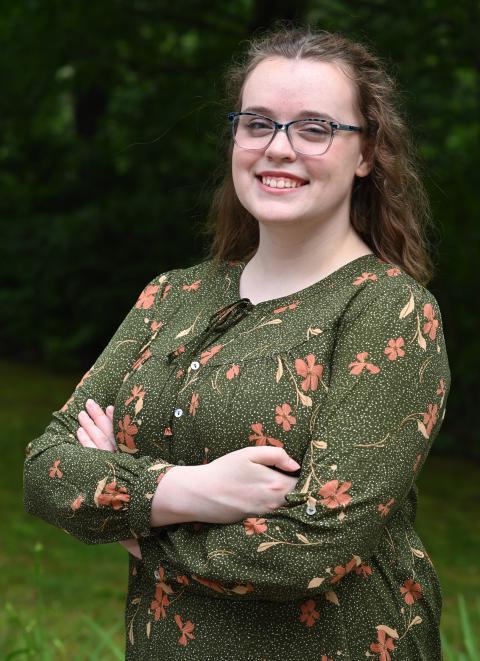 McNair scholar, professionally dressed, wooded backdrop