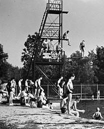 Vintage photo of old UNH Pool Diving Tower at old outdoor pool; swimmers.