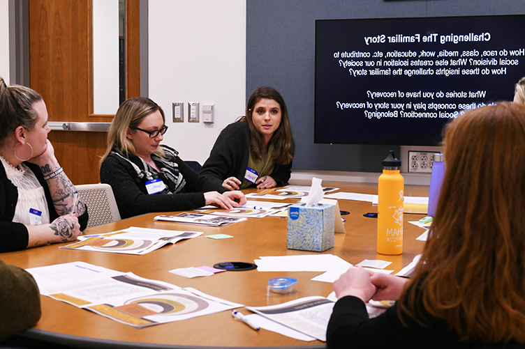 students participating in dialogue around a table