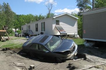 car in sinkhole by mobile home