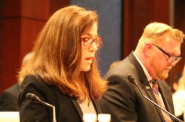 Sharyn Potter testifying before Congress with male in background