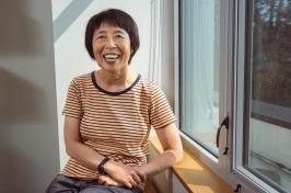 Ju-Chin Huang sits by a window inside her office.