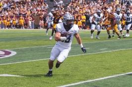 Dylan Laube runs with the ball