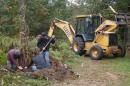 students landscaping with bulldozer assistance