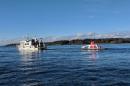 Autonomous surface vehicle at sea behind a research vessel