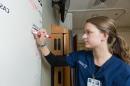 nursing student working on white board