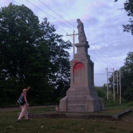 statue with person pointing up at it